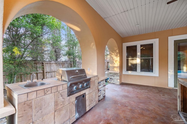 view of patio featuring an outdoor kitchen, sink, and grilling area