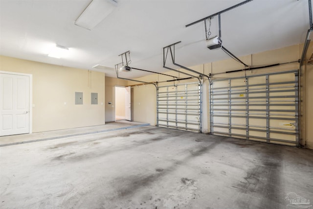 garage featuring a garage door opener and electric panel