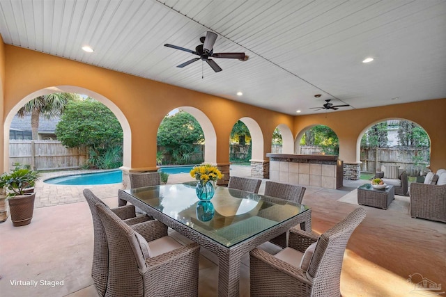 view of patio with a fenced in pool and ceiling fan