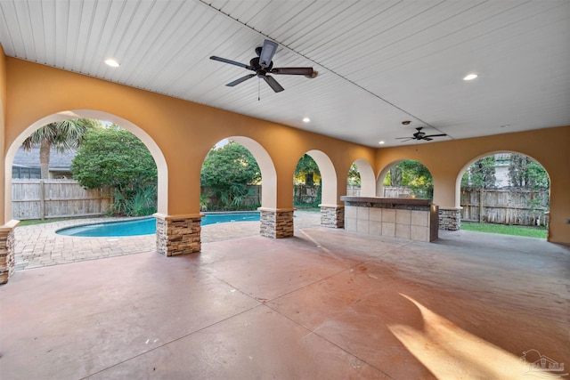 view of patio with a fenced in pool and ceiling fan