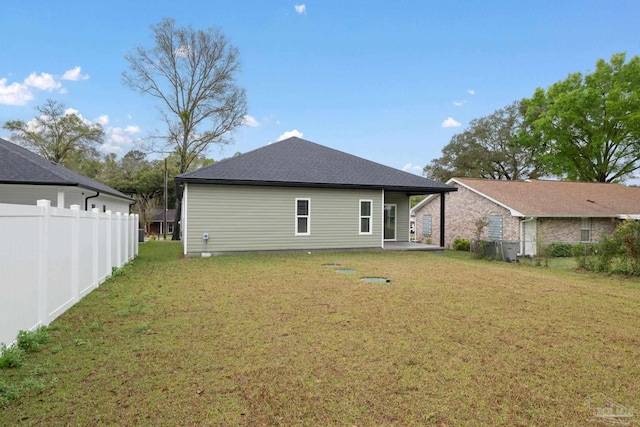 back of house featuring a patio area, fence, and a lawn