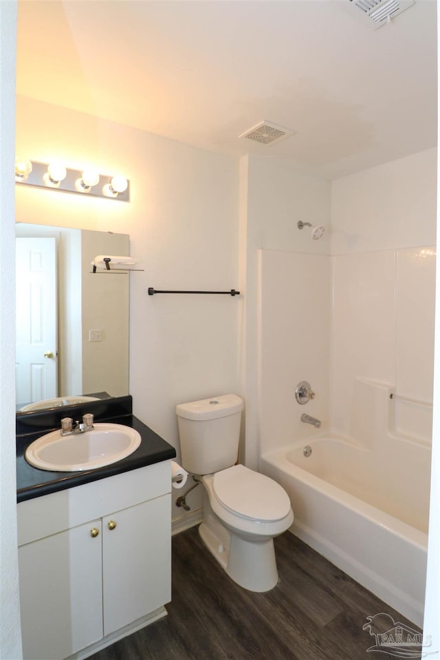 full bathroom featuring vanity, toilet, hardwood / wood-style floors, and shower / bath combination