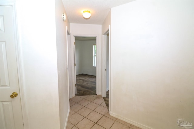 hall featuring light tile patterned floors