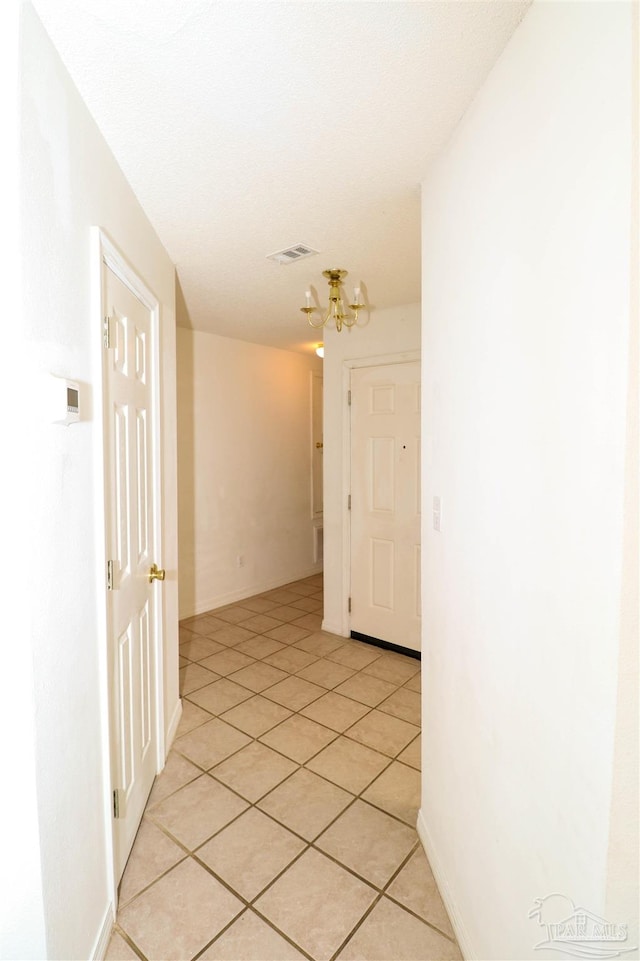 hall featuring light tile patterned floors