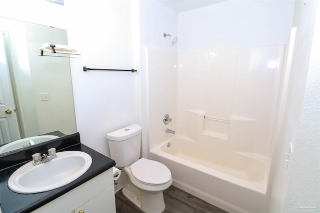 full bathroom with hardwood / wood-style floors, toilet, bathtub / shower combination, and vanity