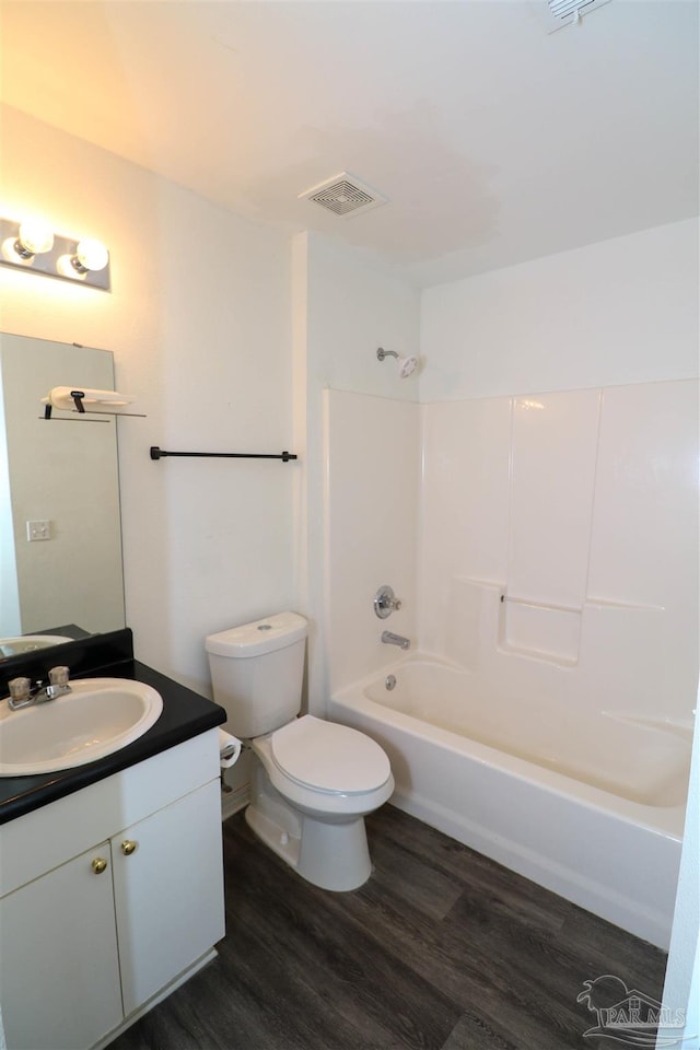 full bathroom featuring shower / bathing tub combination, vanity, toilet, and hardwood / wood-style flooring