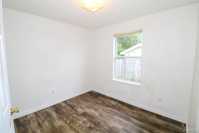 spare room featuring dark hardwood / wood-style floors