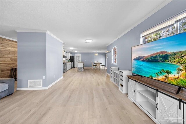 931 Pocahontas Dr, Ft Walton Beach, FL 32547 - living room featuring crown molding, wooden walls, a textured ceiling, and light wood-type flooring