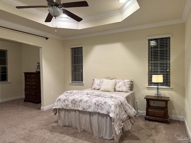 bedroom featuring ornamental molding, a raised ceiling, light colored carpet, and baseboards