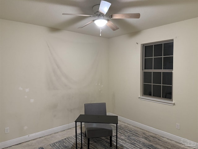 home office featuring a ceiling fan and baseboards