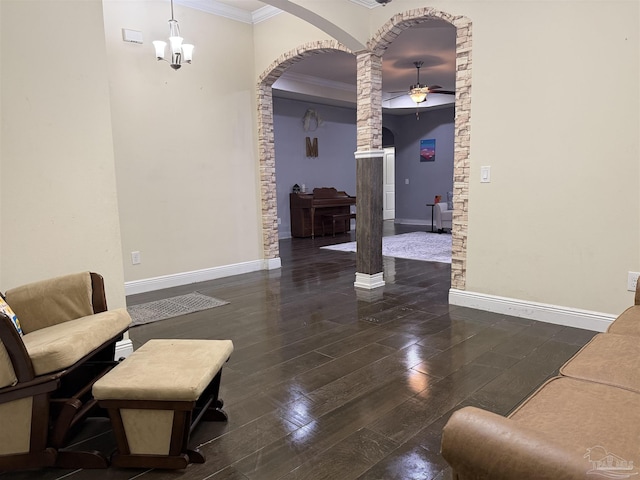 entrance foyer with baseboards, arched walkways, dark wood finished floors, and ornamental molding