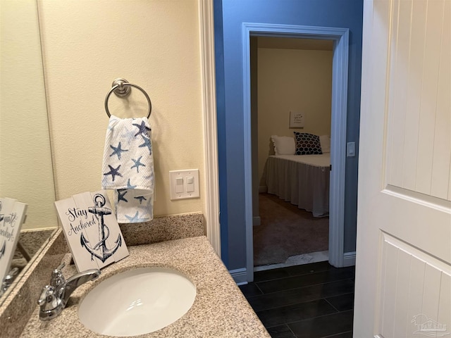 bathroom with vanity and wood finished floors