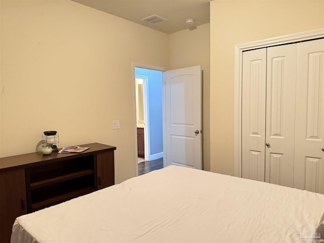 bedroom with a closet and visible vents