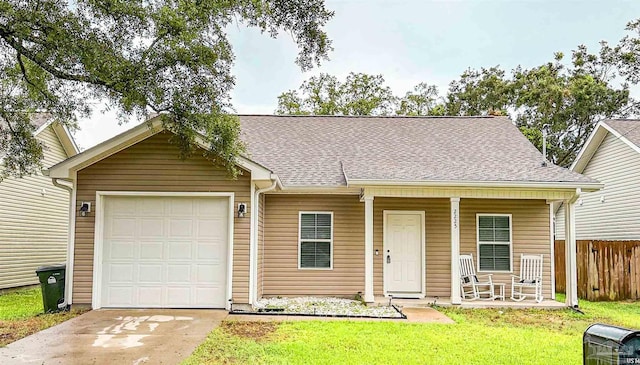 ranch-style home with covered porch, a front yard, and a garage