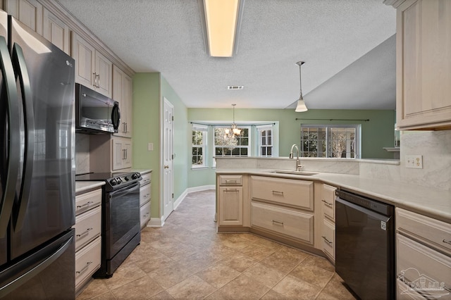 kitchen featuring pendant lighting, kitchen peninsula, sink, and black appliances