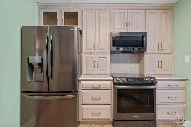 kitchen with stainless steel appliances and cream cabinetry