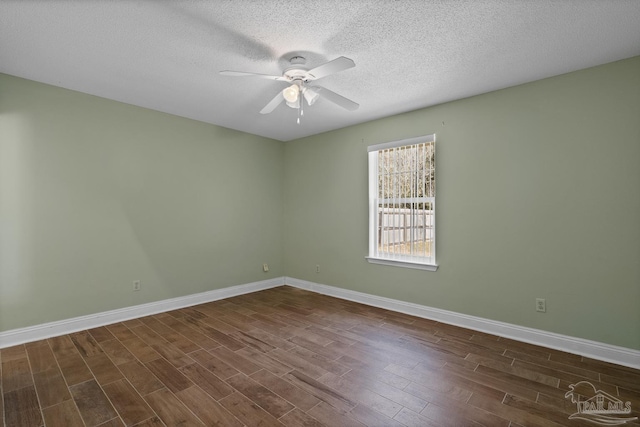 spare room featuring dark hardwood / wood-style flooring, a textured ceiling, and ceiling fan