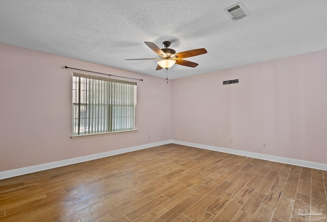 unfurnished room featuring ceiling fan, a textured ceiling, and light wood-type flooring