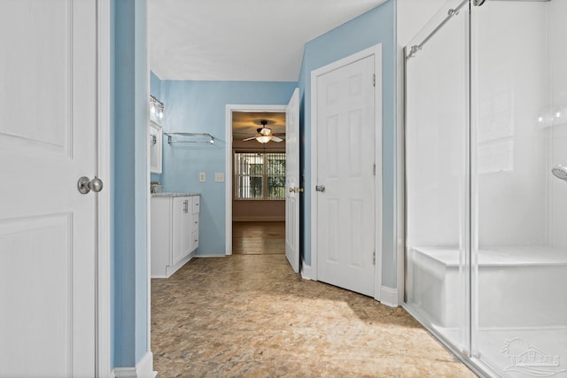 bathroom with ceiling fan and vanity