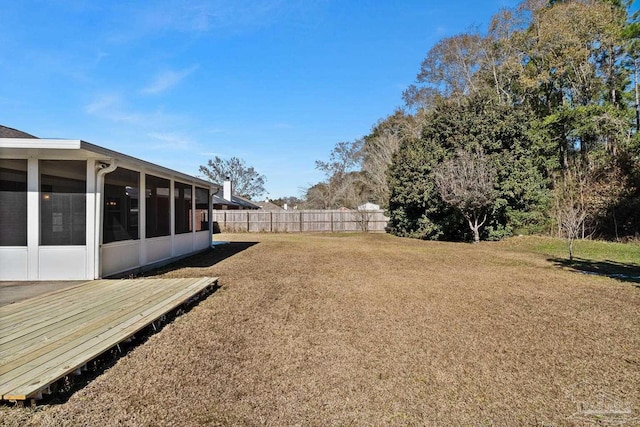 view of yard with a wooden deck and a sunroom