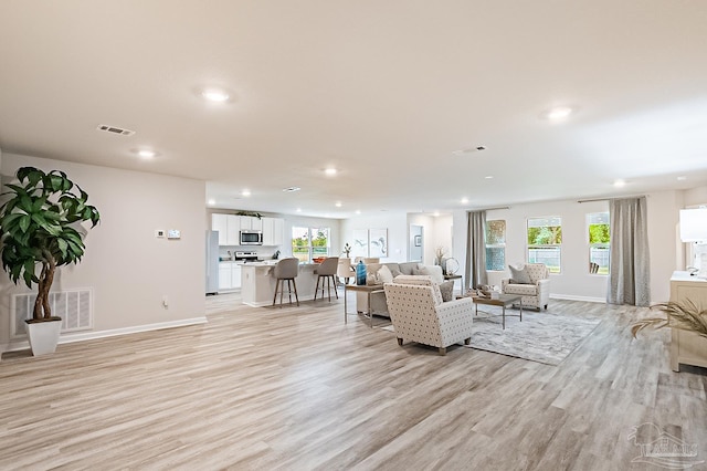 8815 Longmont Way, Milton, FL 32583 - living room featuring light wood-style floors, baseboards, visible vents, and recessed lighting