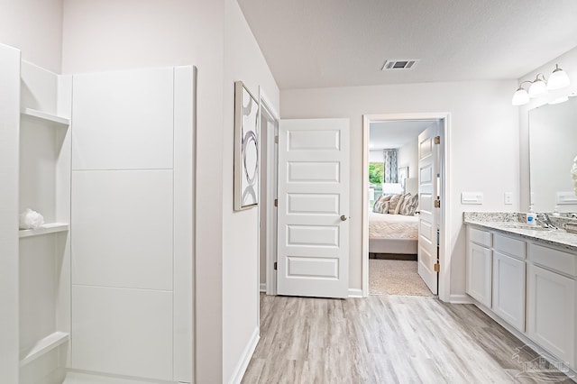 8815 Longmont Way, Milton, FL 32583 - bathroom featuring ensuite bathroom, wood finished floors, vanity, visible vents, and baseboards