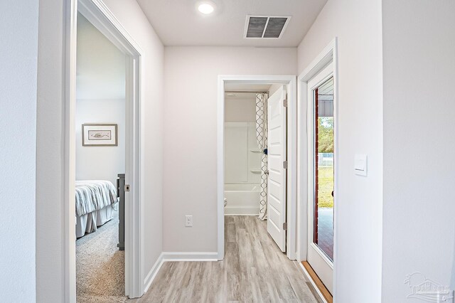 8815 Longmont Way, Milton, FL 32583 - hall with light wood finished floors, visible vents, and baseboards