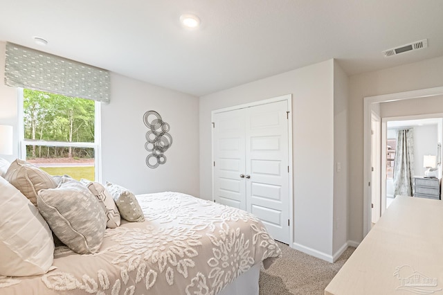 8815 Longmont Way, Milton, FL 32583 - bedroom with baseboards, a closet, visible vents, and carpet