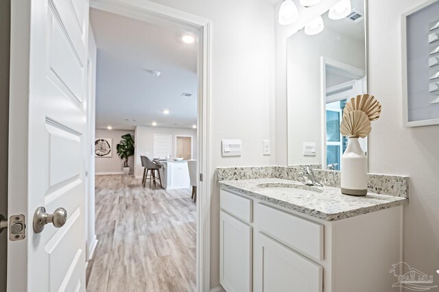 8815 Longmont Way, Milton, FL 32583 - bathroom featuring visible vents, wood finished floors, vanity, and recessed lighting
