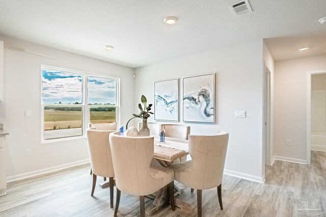 8815 Longmont Way, Milton, FL 32583 - dining space featuring baseboards, light wood-type flooring, and visible vents