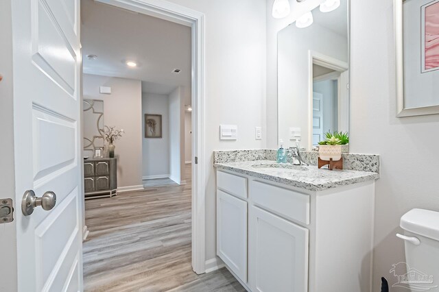 8815 Longmont Way, Milton, FL 32583 - half bath featuring toilet, baseboards, vanity, and wood finished floors