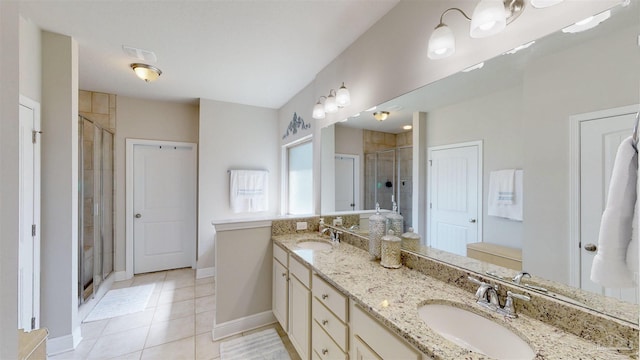 bathroom with tile patterned flooring, vanity, and a shower with shower door