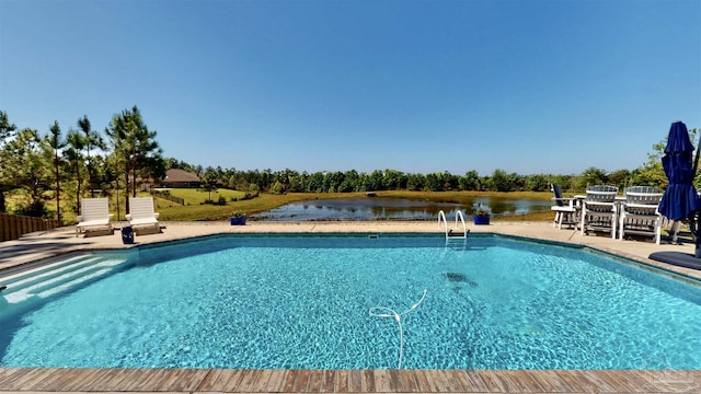 view of pool featuring a patio area and a water view