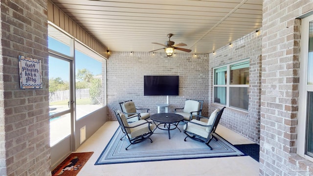 sunroom with a wealth of natural light and ceiling fan