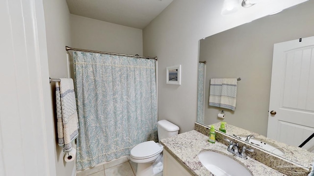 bathroom featuring tile patterned flooring, a shower with curtain, vanity, and toilet