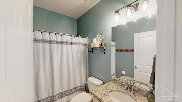 bathroom with vanity, a shower with shower curtain, and toilet