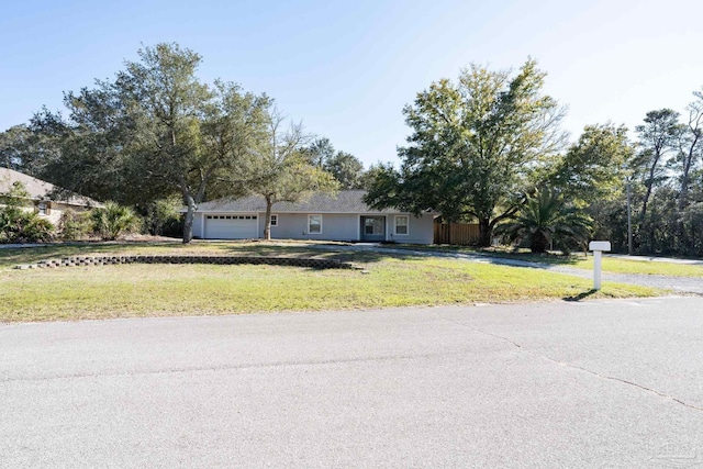 ranch-style home featuring a garage and a front yard