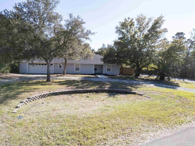 ranch-style home with a front lawn and an attached garage