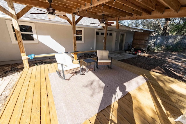 wooden deck with a ceiling fan and fence