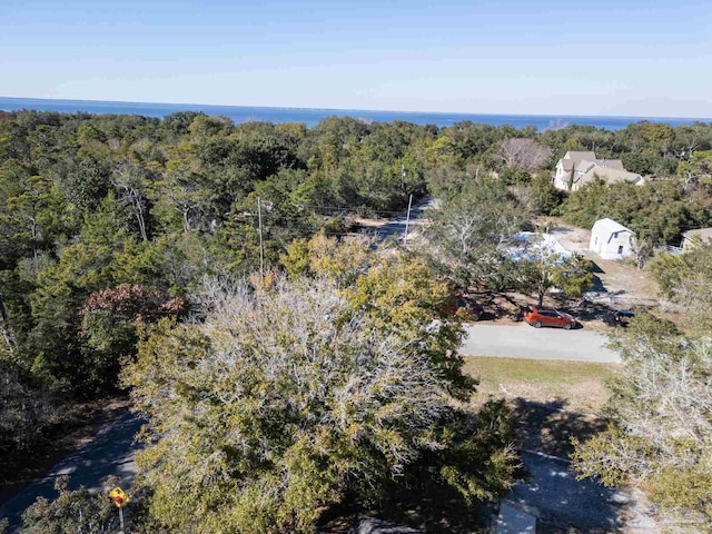 birds eye view of property featuring a wooded view