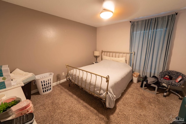 carpeted bedroom featuring baseboards