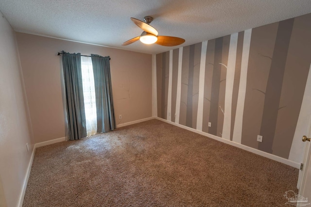 carpeted empty room with a ceiling fan, a textured ceiling, and baseboards