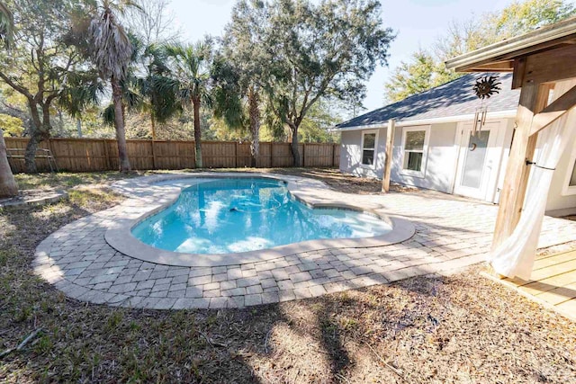 view of swimming pool with a fenced in pool, a fenced backyard, and a patio