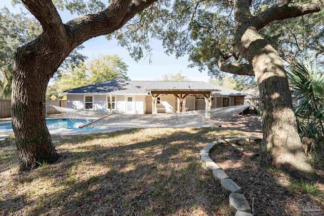 back of house with a fenced in pool, a patio area, and fence