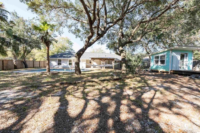 rear view of property with a fenced backyard, a fenced in pool, and an outbuilding