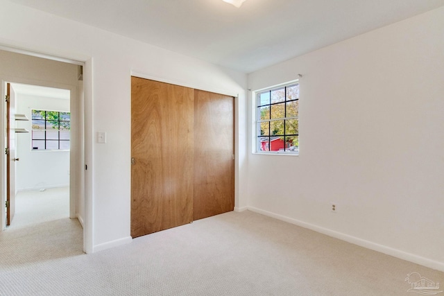 unfurnished bedroom featuring carpet floors and a closet