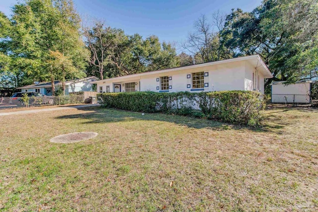 ranch-style home with a front lawn