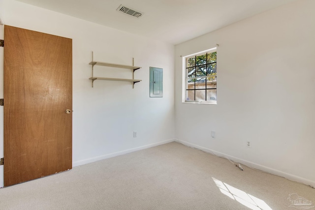 empty room featuring electric panel and carpet flooring