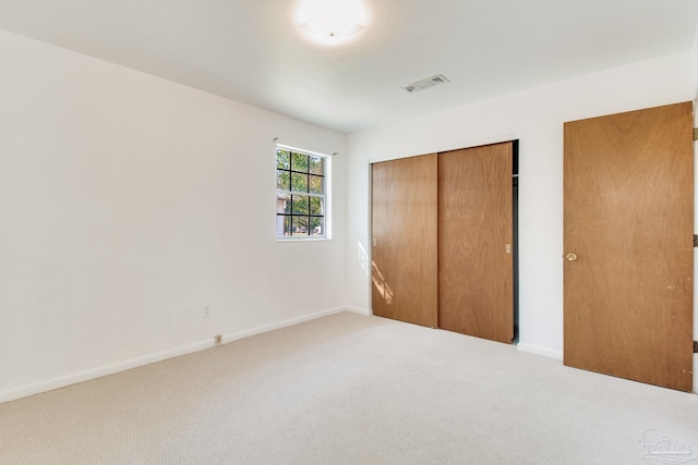 unfurnished bedroom featuring a closet and carpet