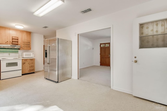 kitchen with light brown cabinets, white appliances, and light colored carpet